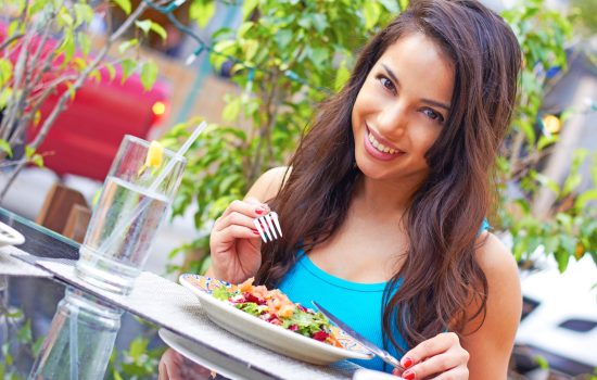 healthy dining out tips woman enjoying nutritious meal